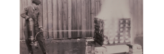 A soda acid fire extinguisher undergoing testing at Underwriters Laboratories, circa 1910s. These extinguishers were the first UL-labeled devices. 