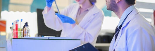 A man and a woman in a laboratory