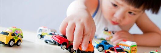 Boy playing with toy cars