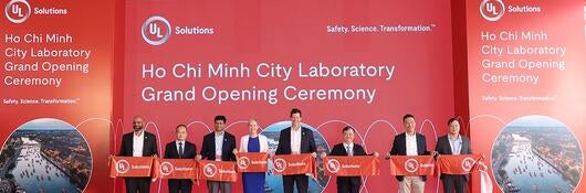 Business leaders cutting a ribbon at Vietnam facility