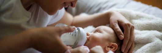 Mother feeding a baby with a bottle 