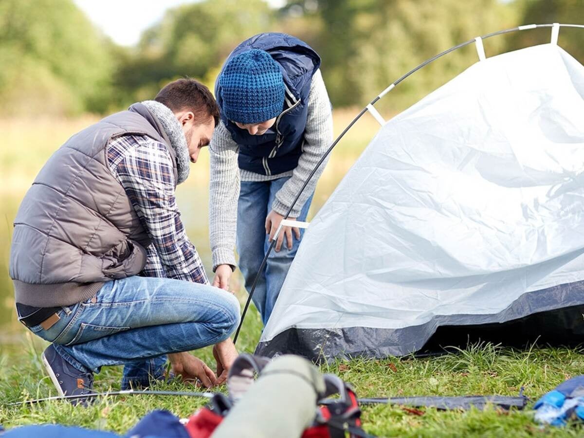 Couple setting up tent for a camping adventure