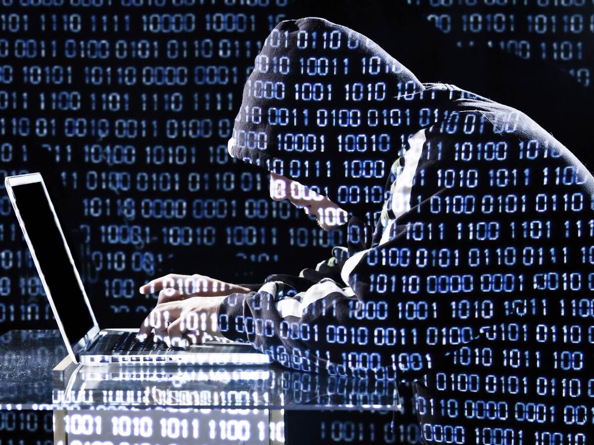 Hacker typing on a laptop, Hacker typing on a laptop