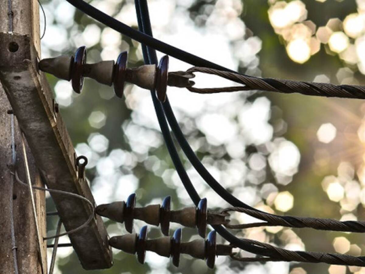 wire on a power pole on green nature background, woman running