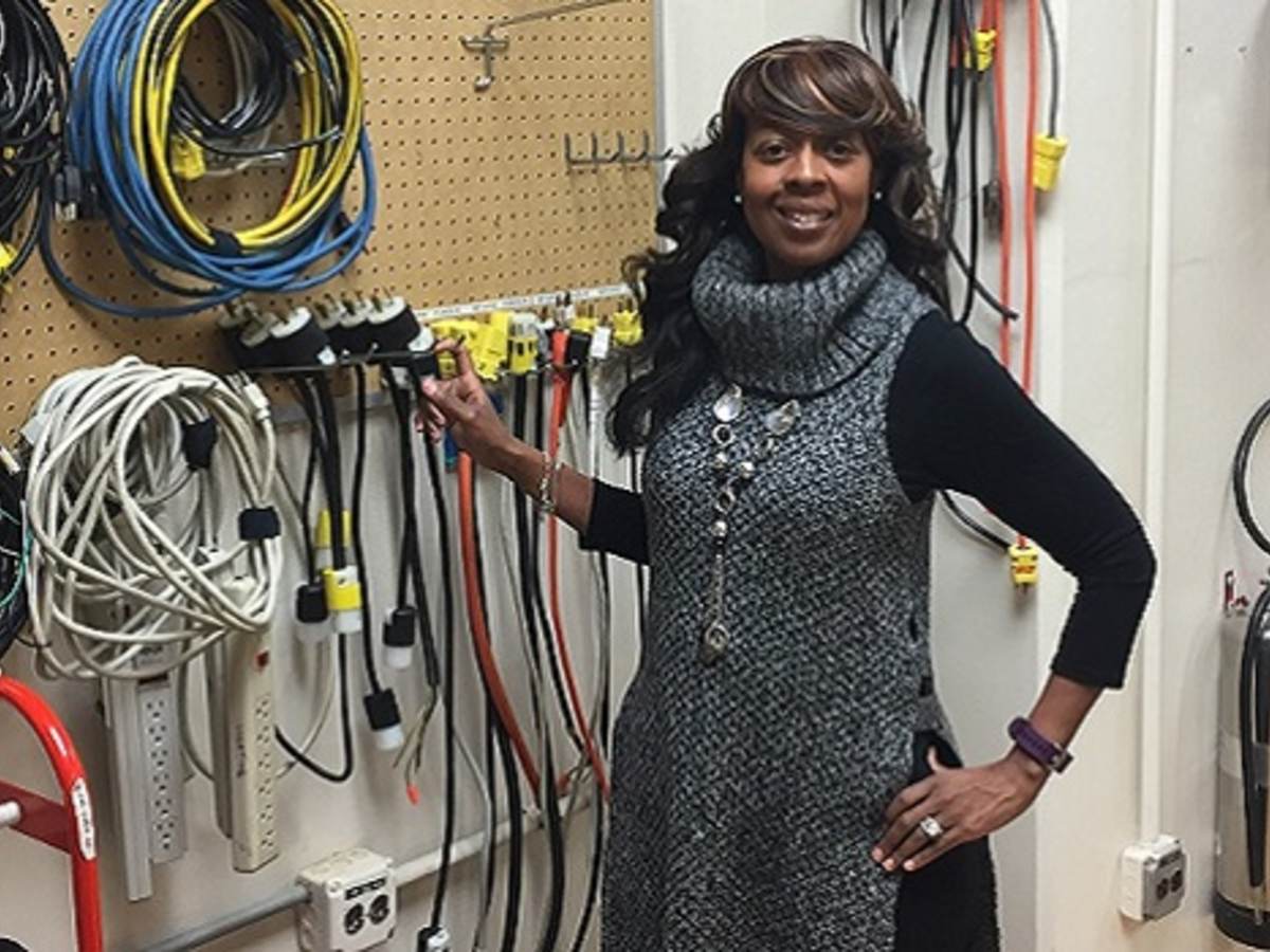 LeVette Martin stands before electrical equipment in UL lab