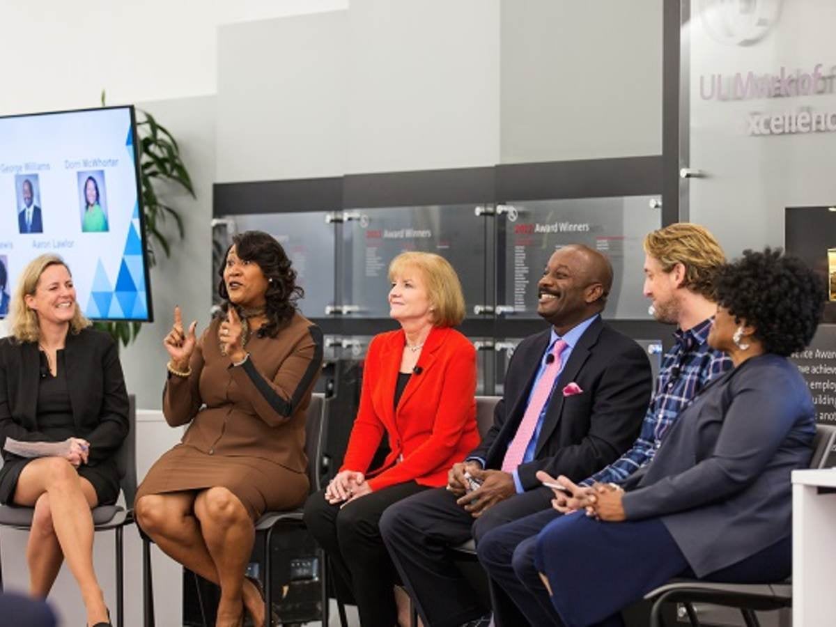 Panel picture of Gitte Schjotz,; Dorri McWhorter; Marla Gottschalk; George Williams; Aaron Lawlor; Wendy Lewis, Wearing a red jacket, Marla Gottschalk speaks before the crowd, UL employee asks question of panel, , 