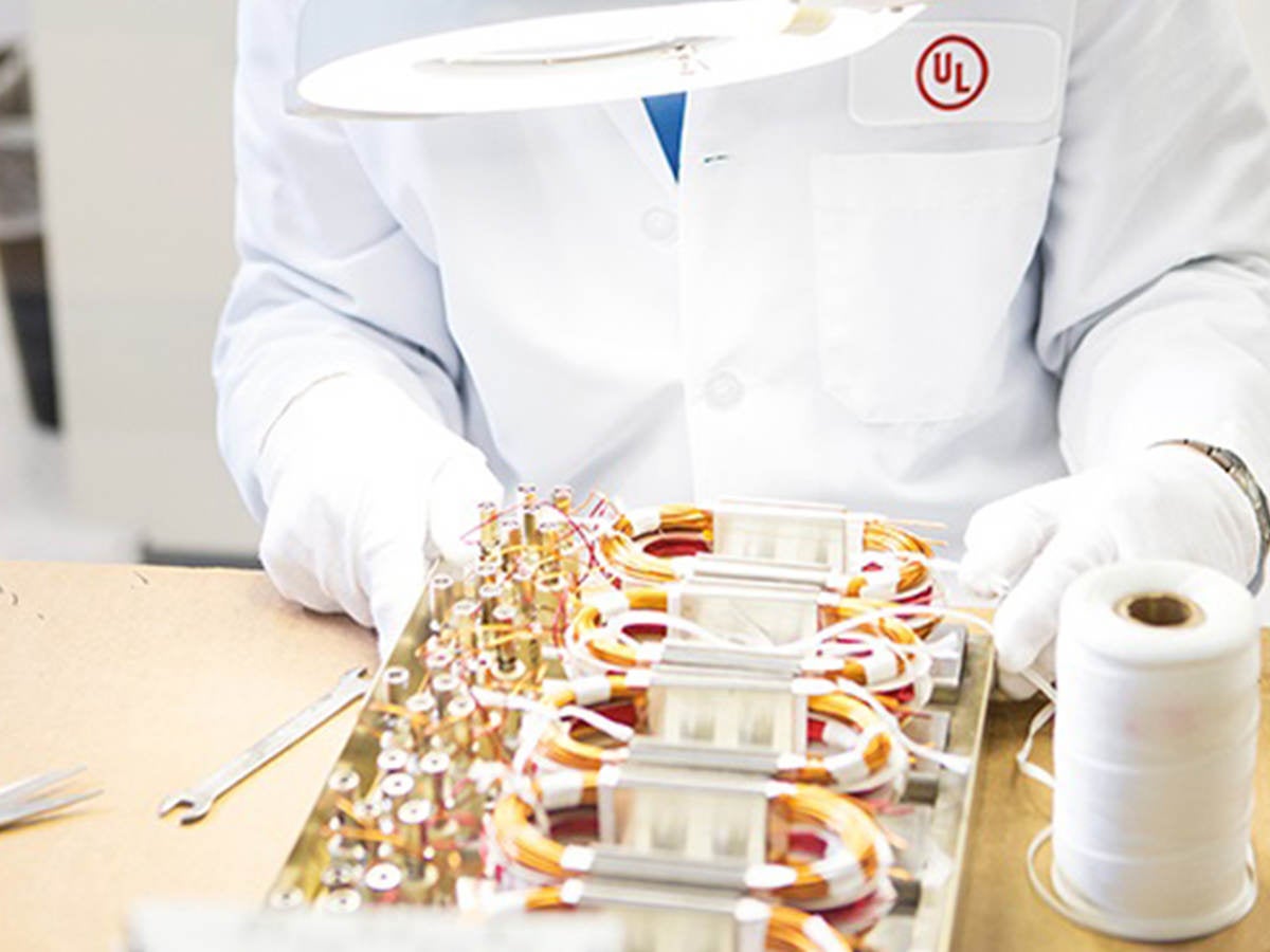 A UL laboratory worker examining a wire board. 