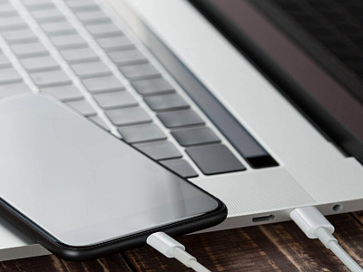 A smartphone using a USB Type-C cable to connect to a laptop.  
