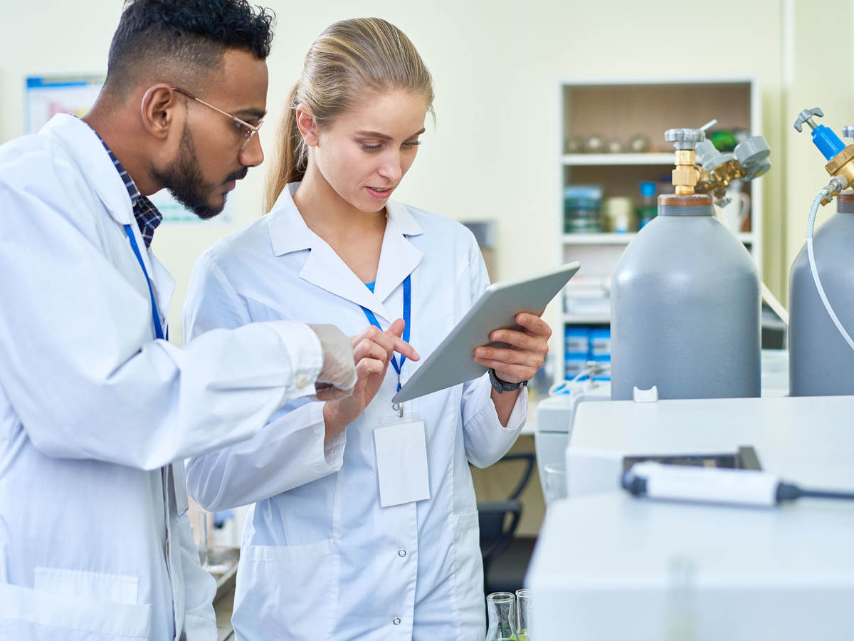 Researchers looking at data on a tablet