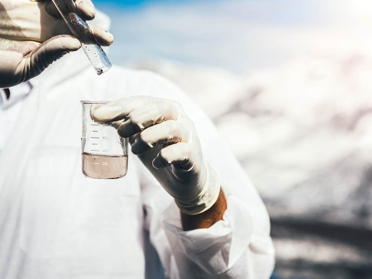 Close-up of person testing water sample.