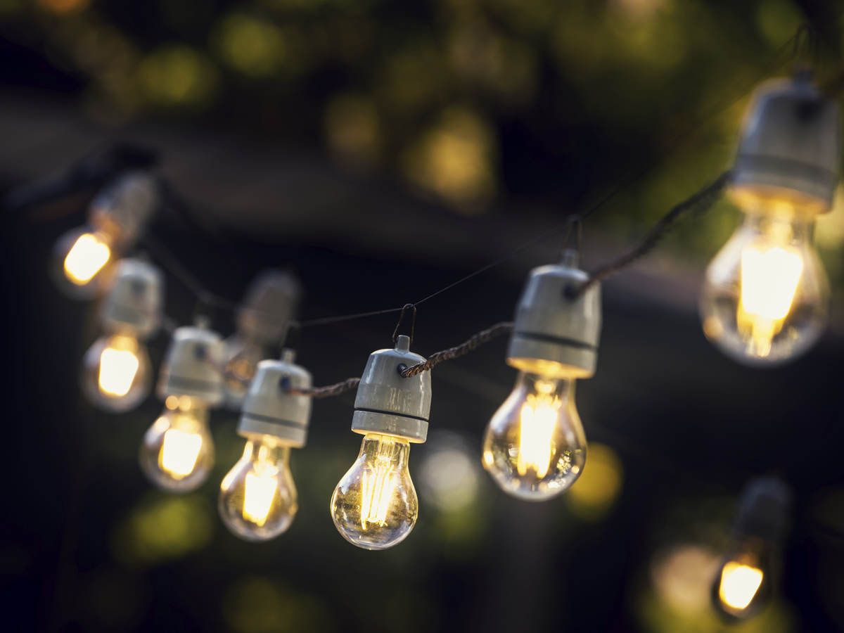 A strand of string lights in an outdoor setting. 