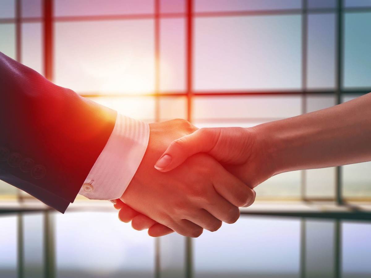 two hands shaking displays trust
