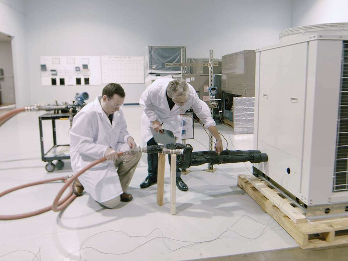 Two UL engineers testing an HVAC unit in a laboratory