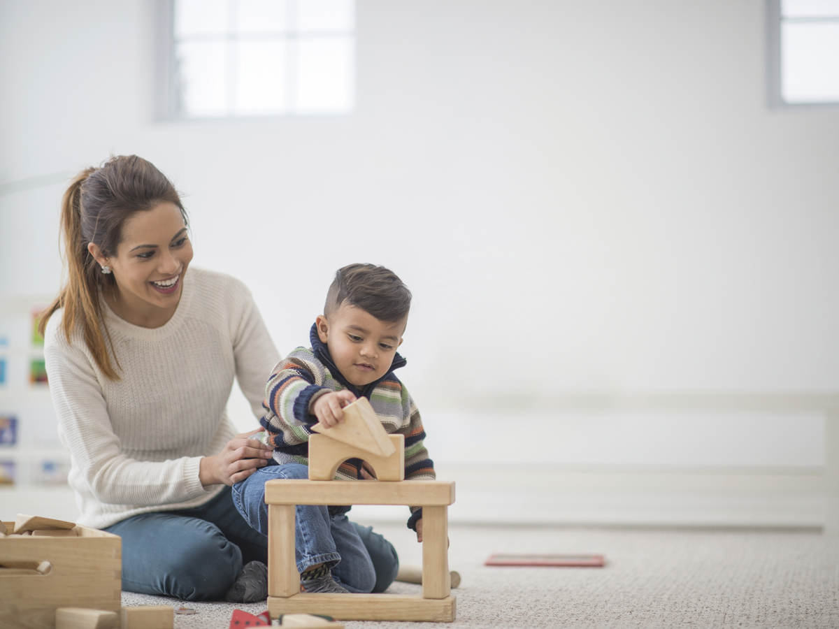 Parent and child playing with toys