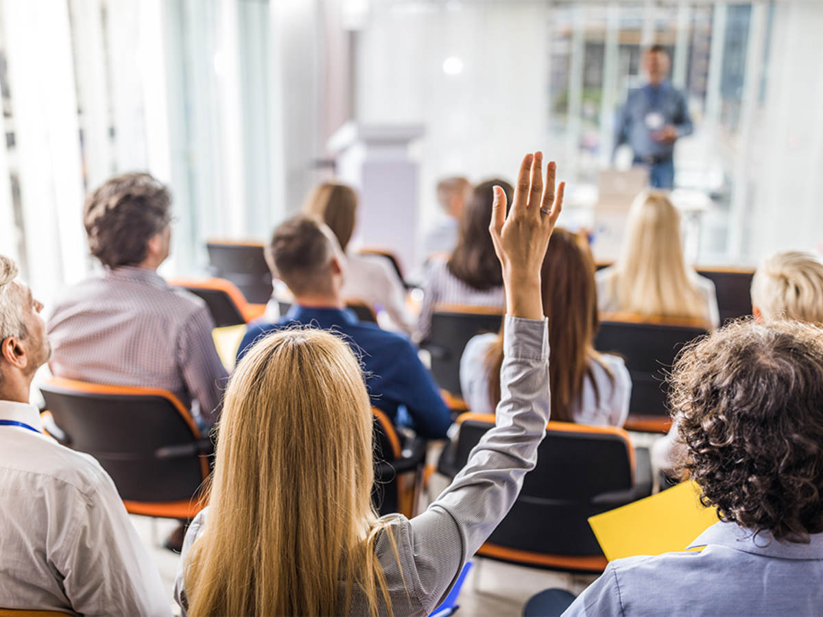 Business people attending a seminar in board room