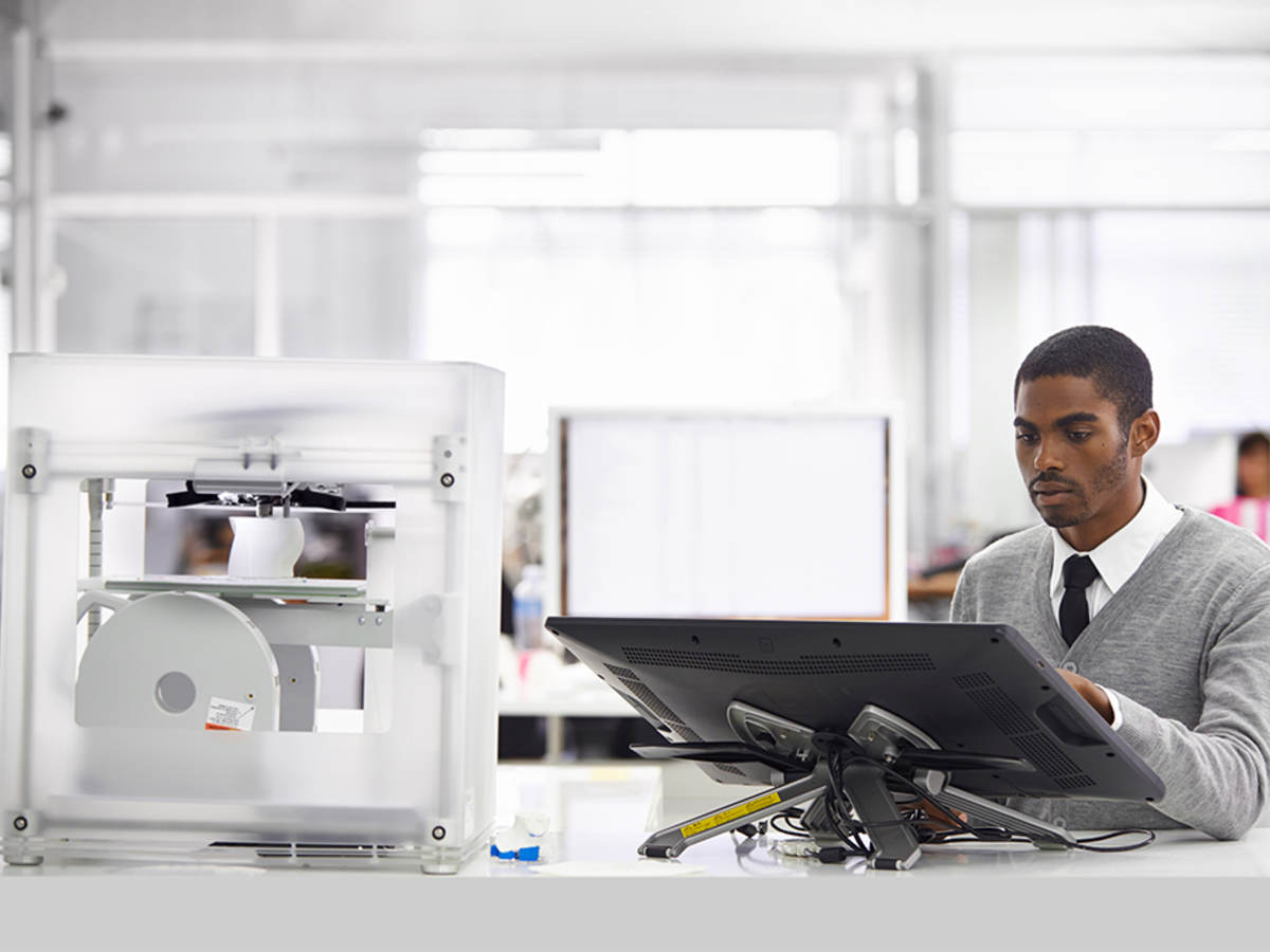 Man designing a product being printed on a 3D printer