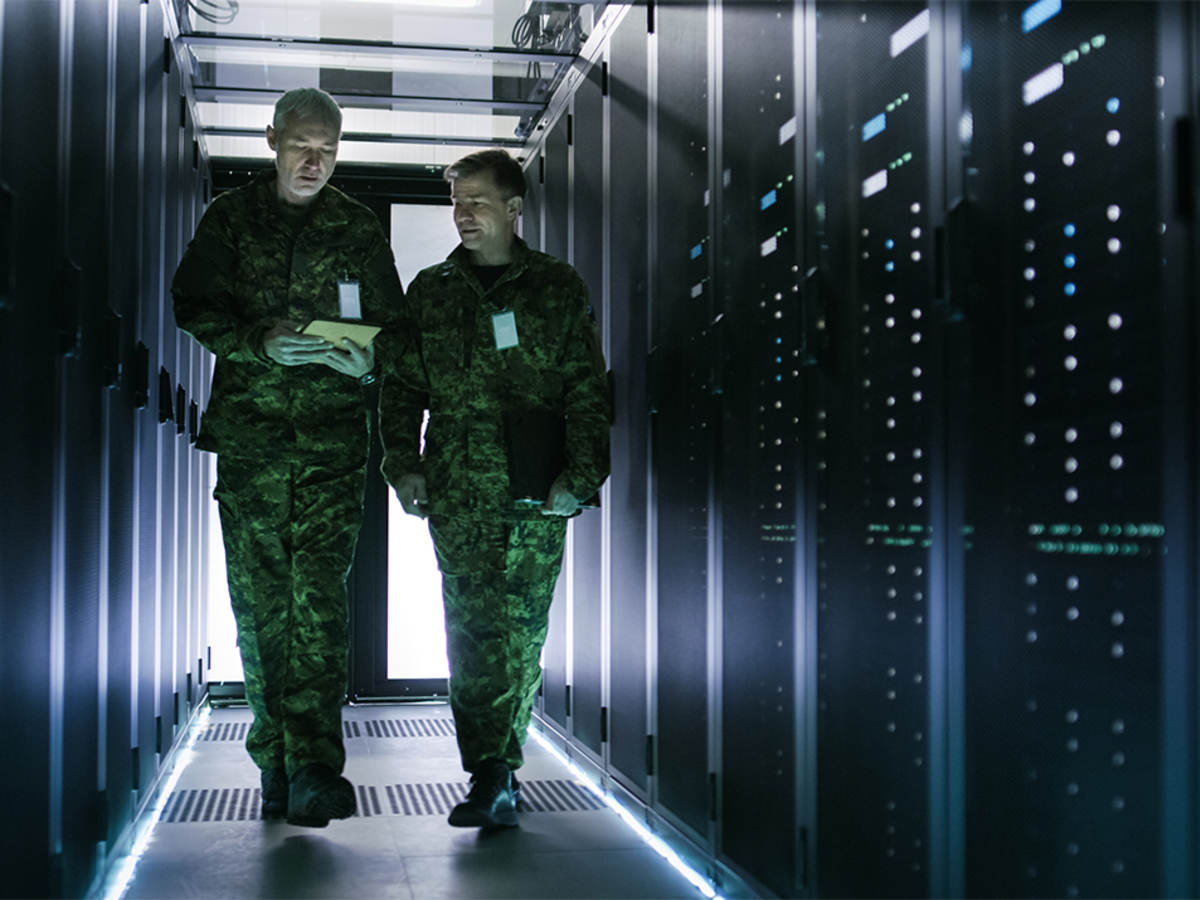 Two military men walking in data center corridor