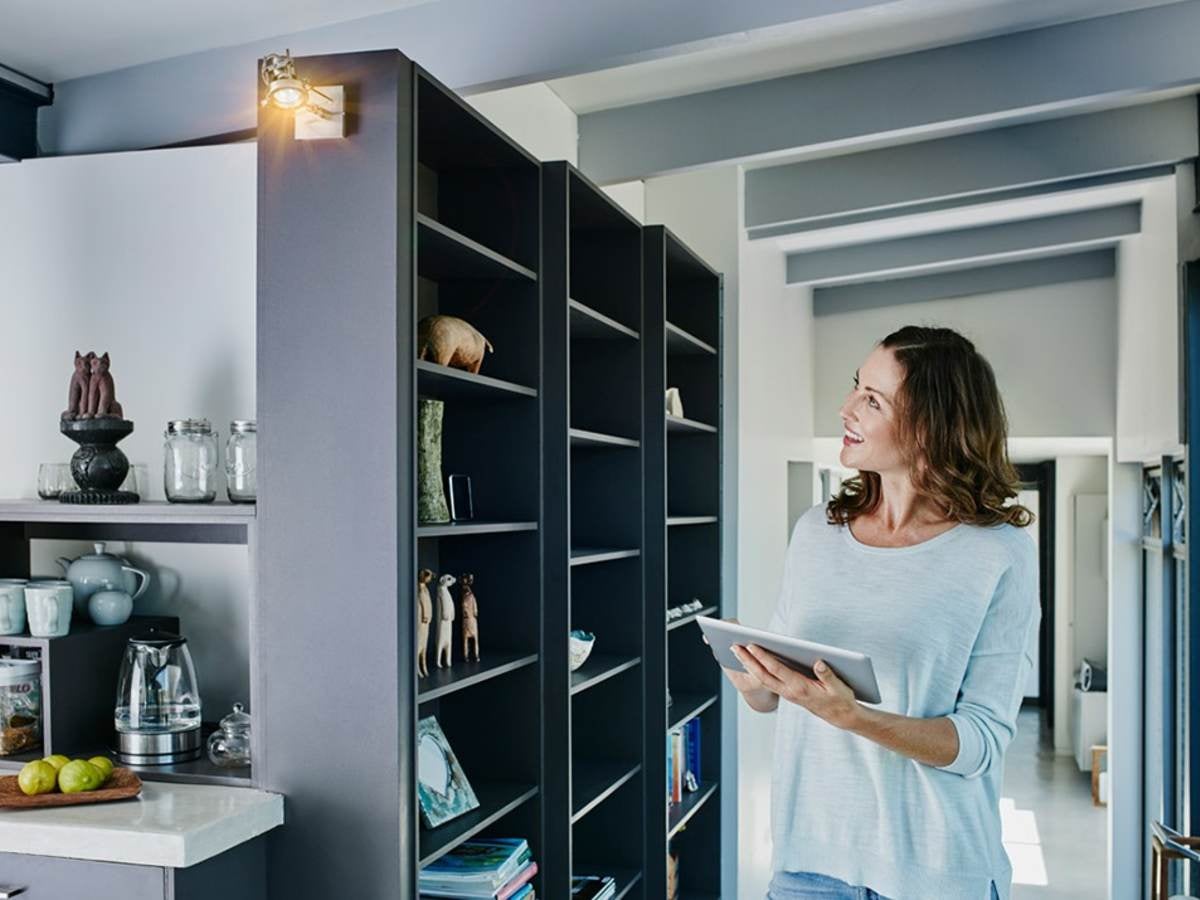 Woman on smart device in smart home