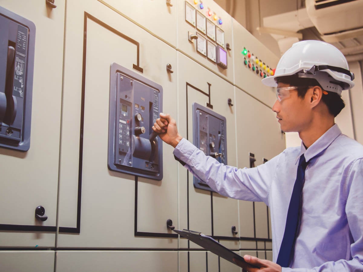 Worker testing a switch