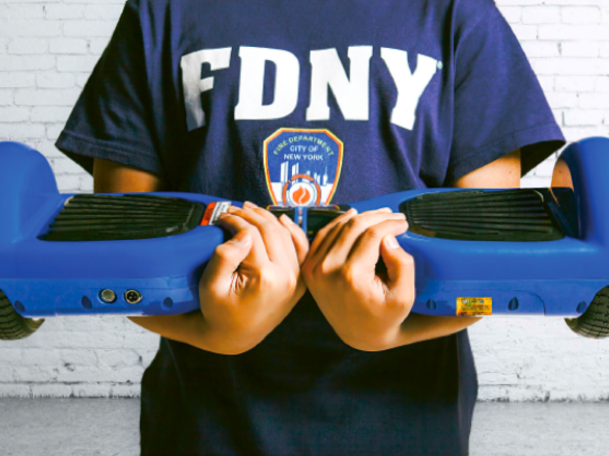 Person with FDNY tshirt holding a hover board
