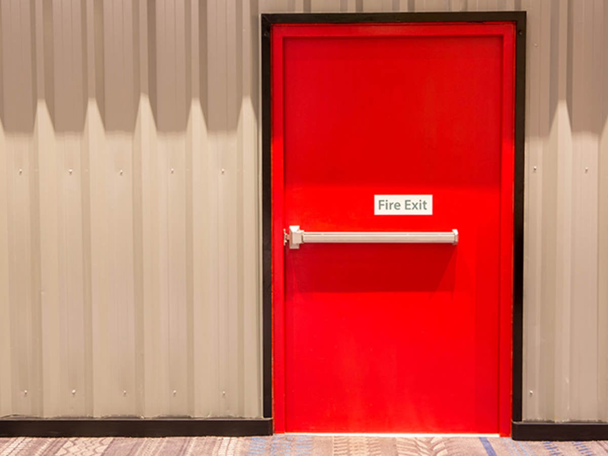 Red door with fire exit sign