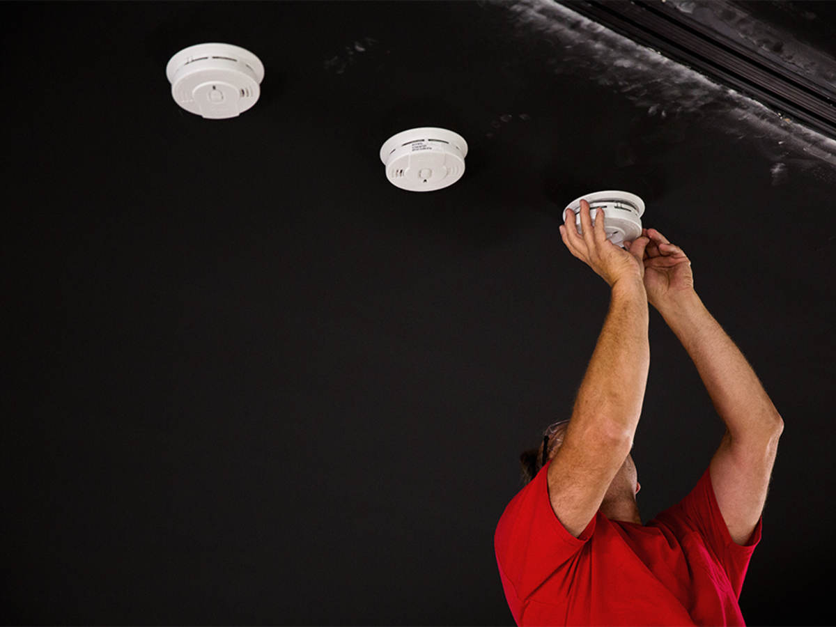 UL engineer installing smoke detectors for testing