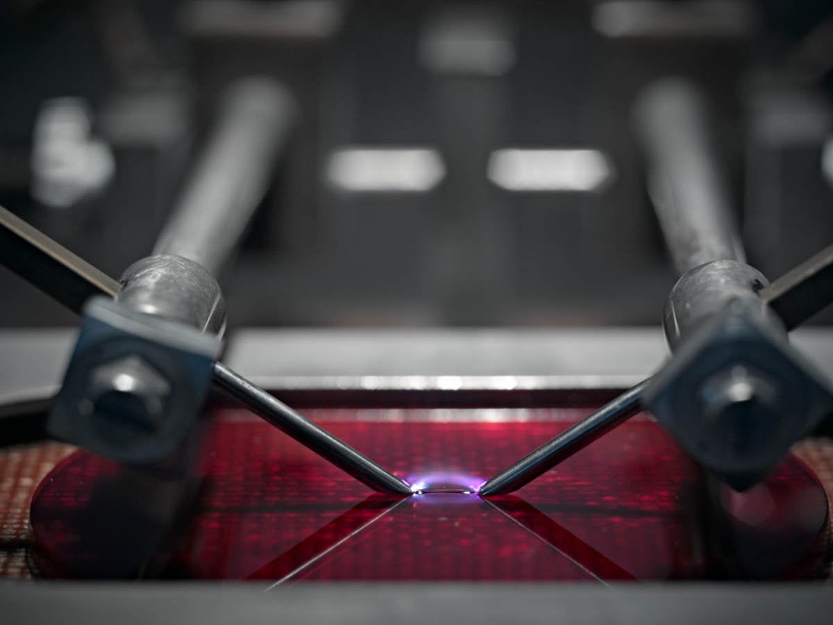 A close-up picture of a machine testing plastic. 