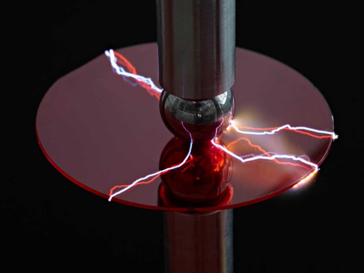 A machine using electricity to test a piece of plastic. 