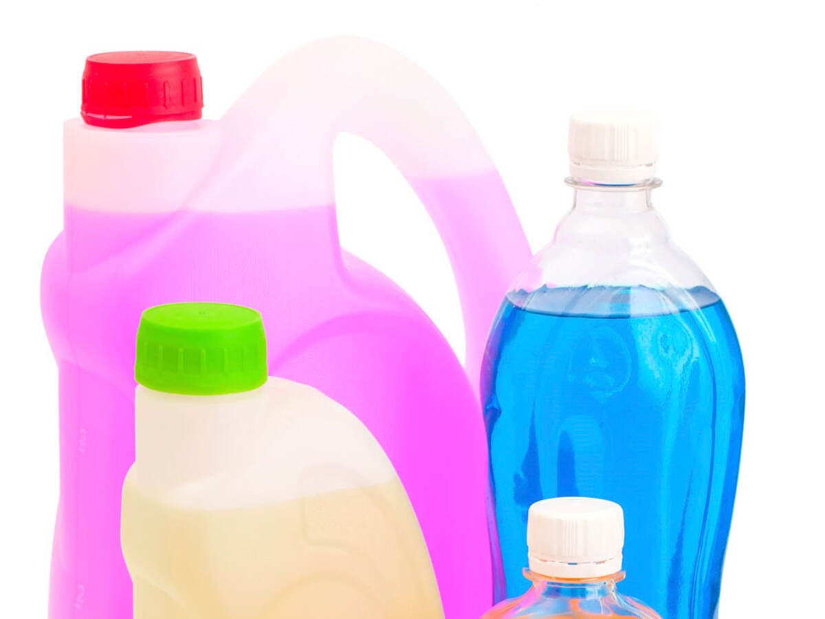 Bottles with different colored cleaning products in them. 