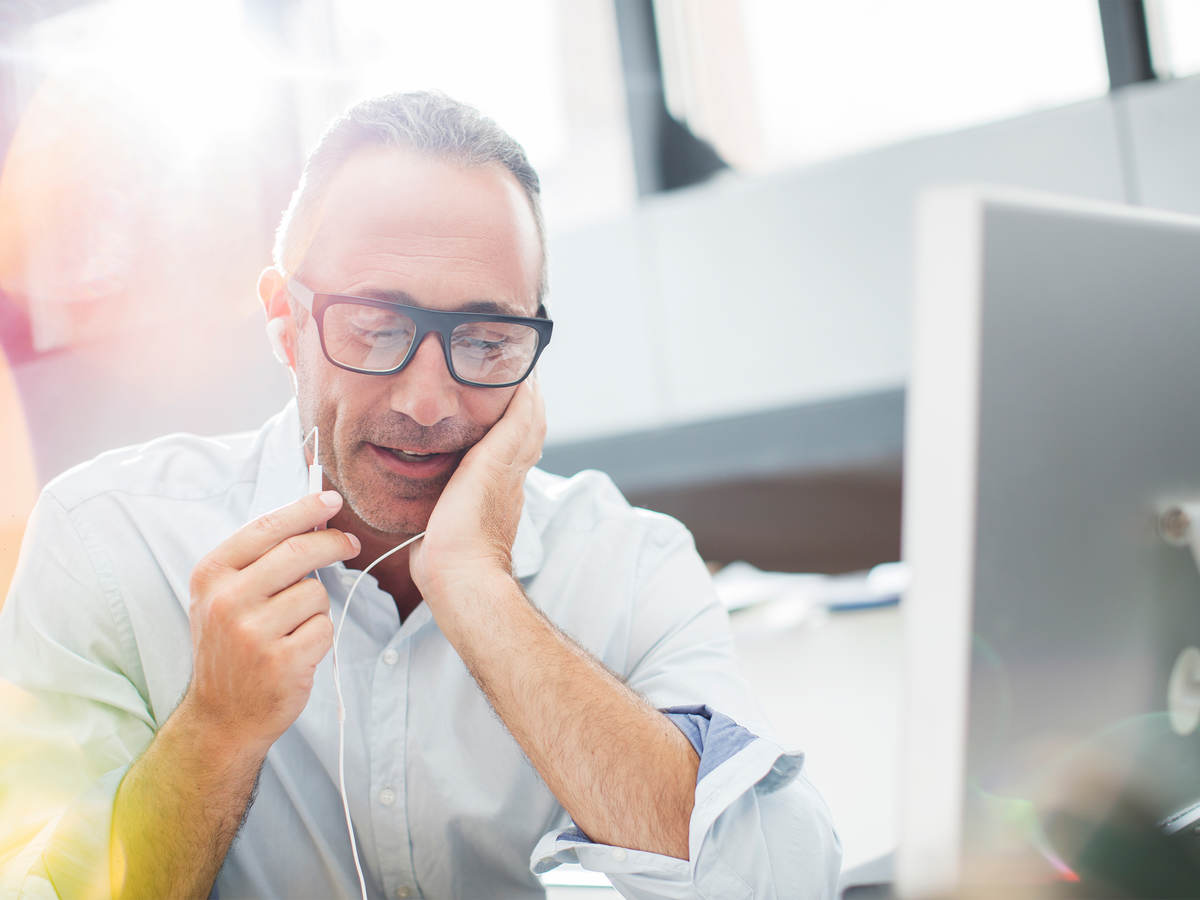 image of a man talking on a phone near a computer