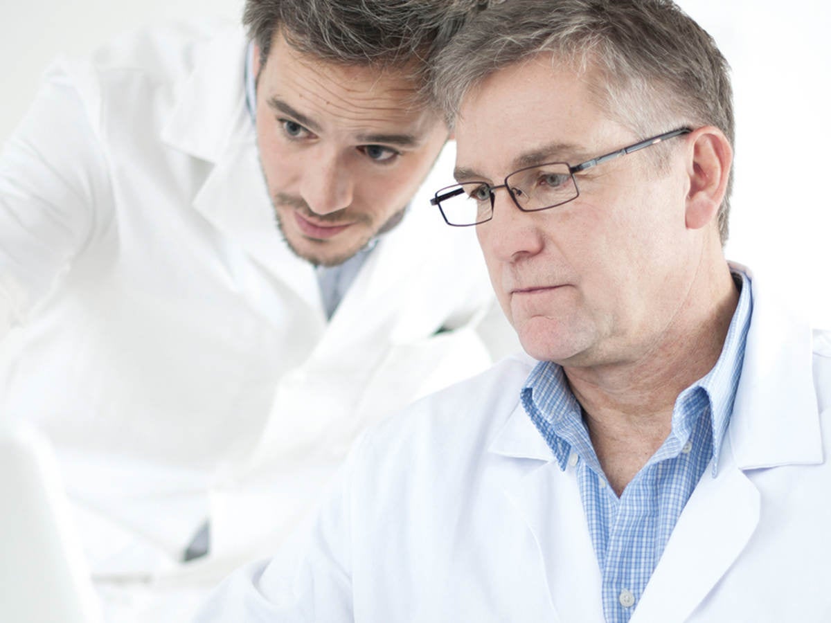 Two scientists work on a computer.