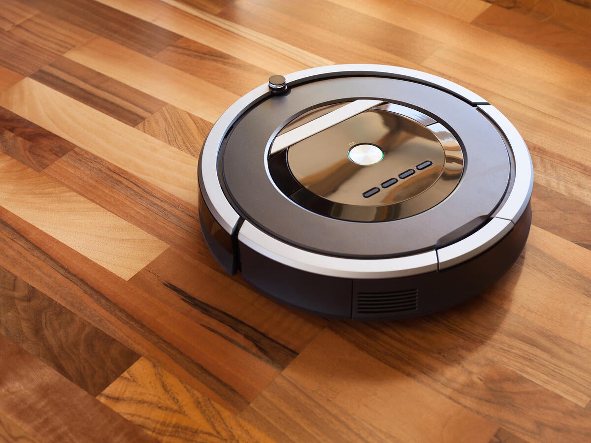 Robotic Vacuum cleaner on laminate wood floor smart cleaning technology
