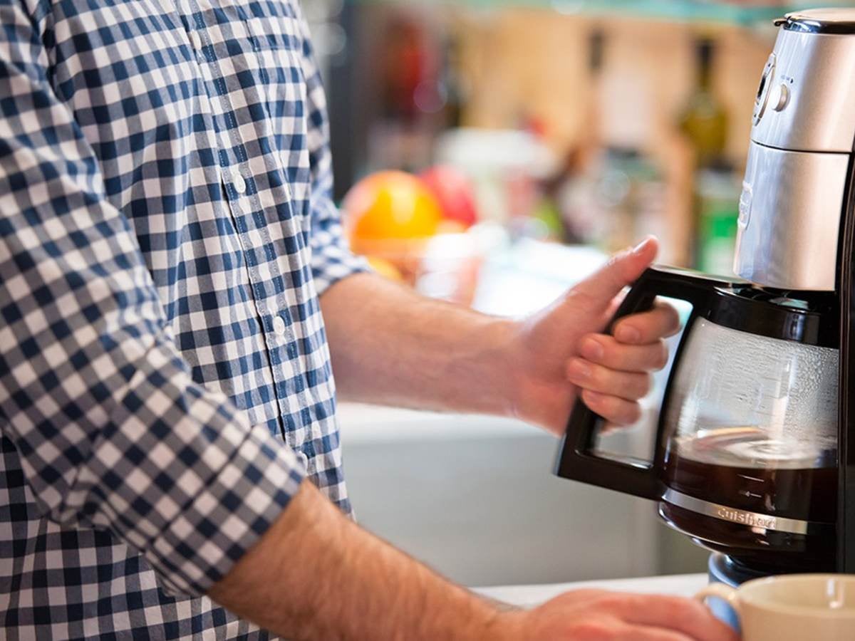 Consumer using a coffee maker