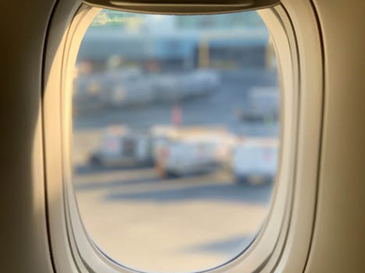 Looking out an airplane window over a tarmac