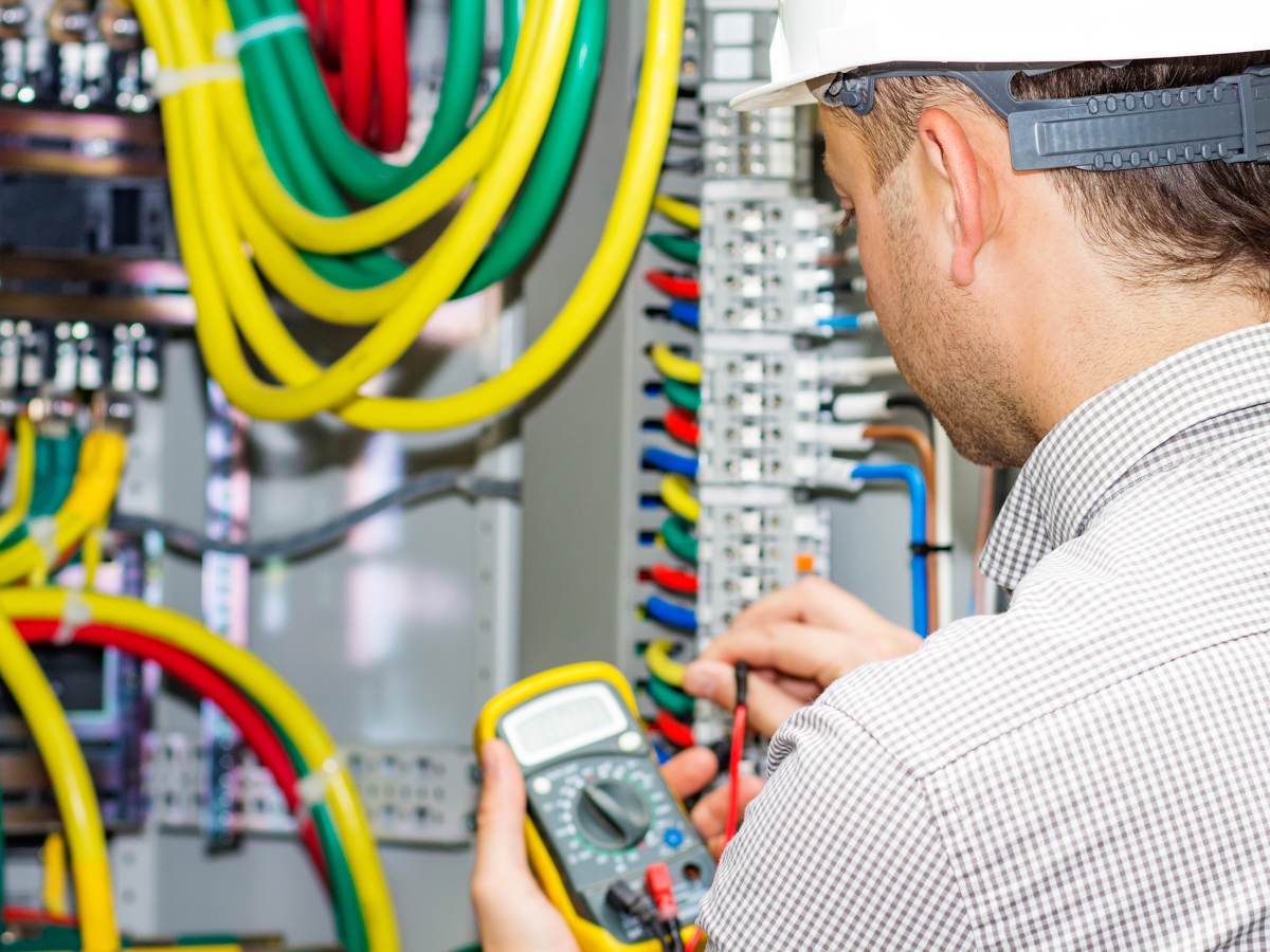 Electrical engineer working in electrical cabinet