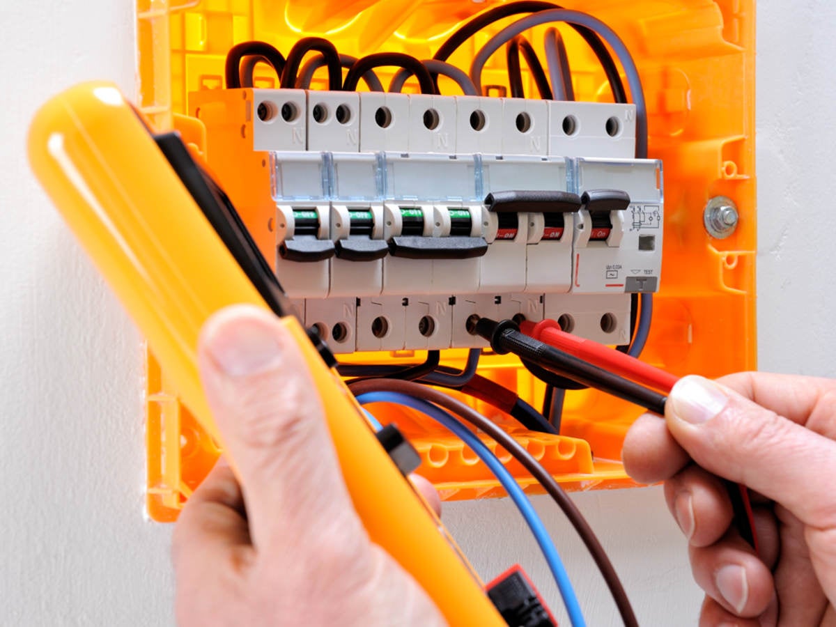 Electrician technician at work on a residential electric panel