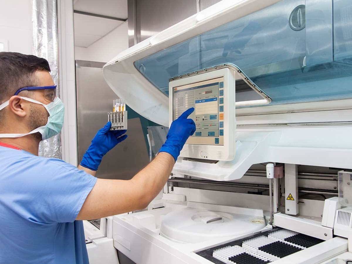 Male nurse checking medical device