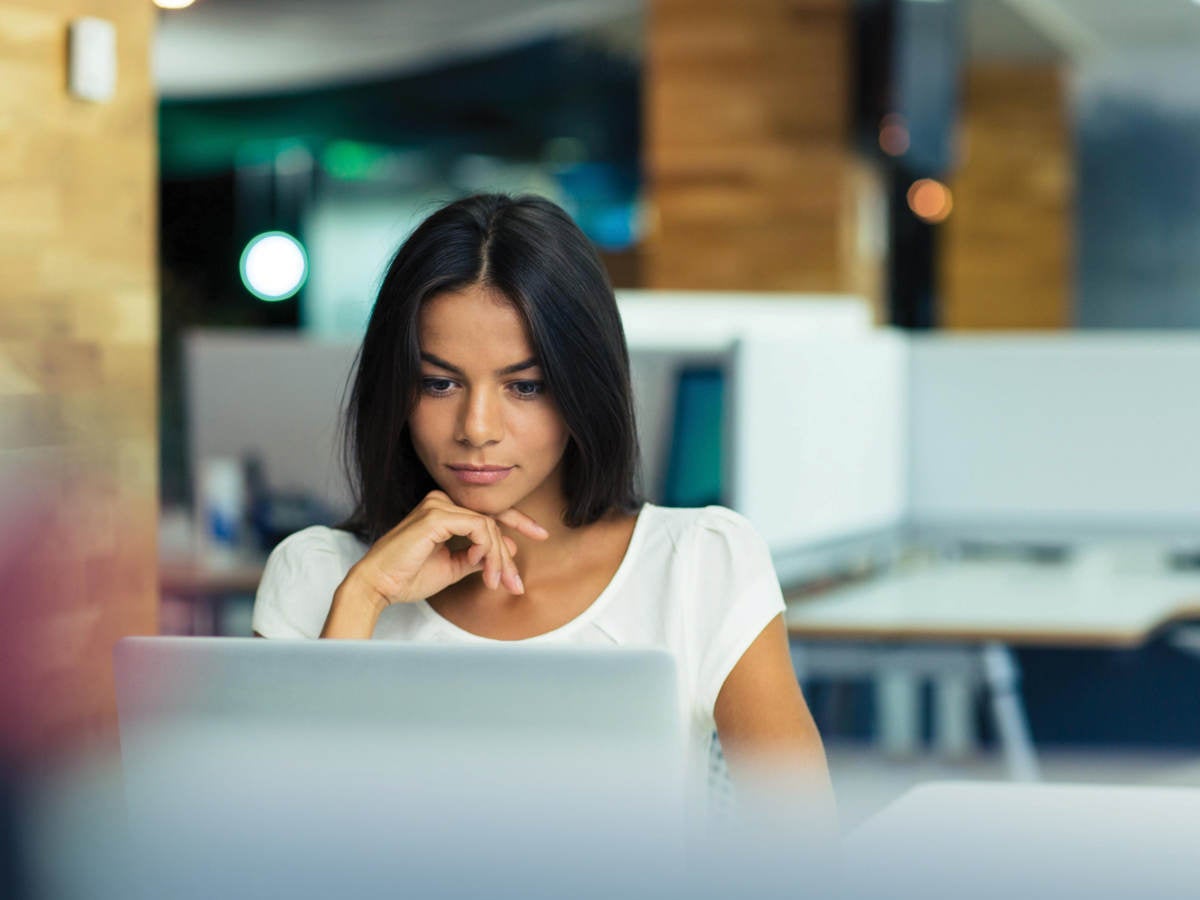 Woman sitting at her desk creating a compliant SDS. 