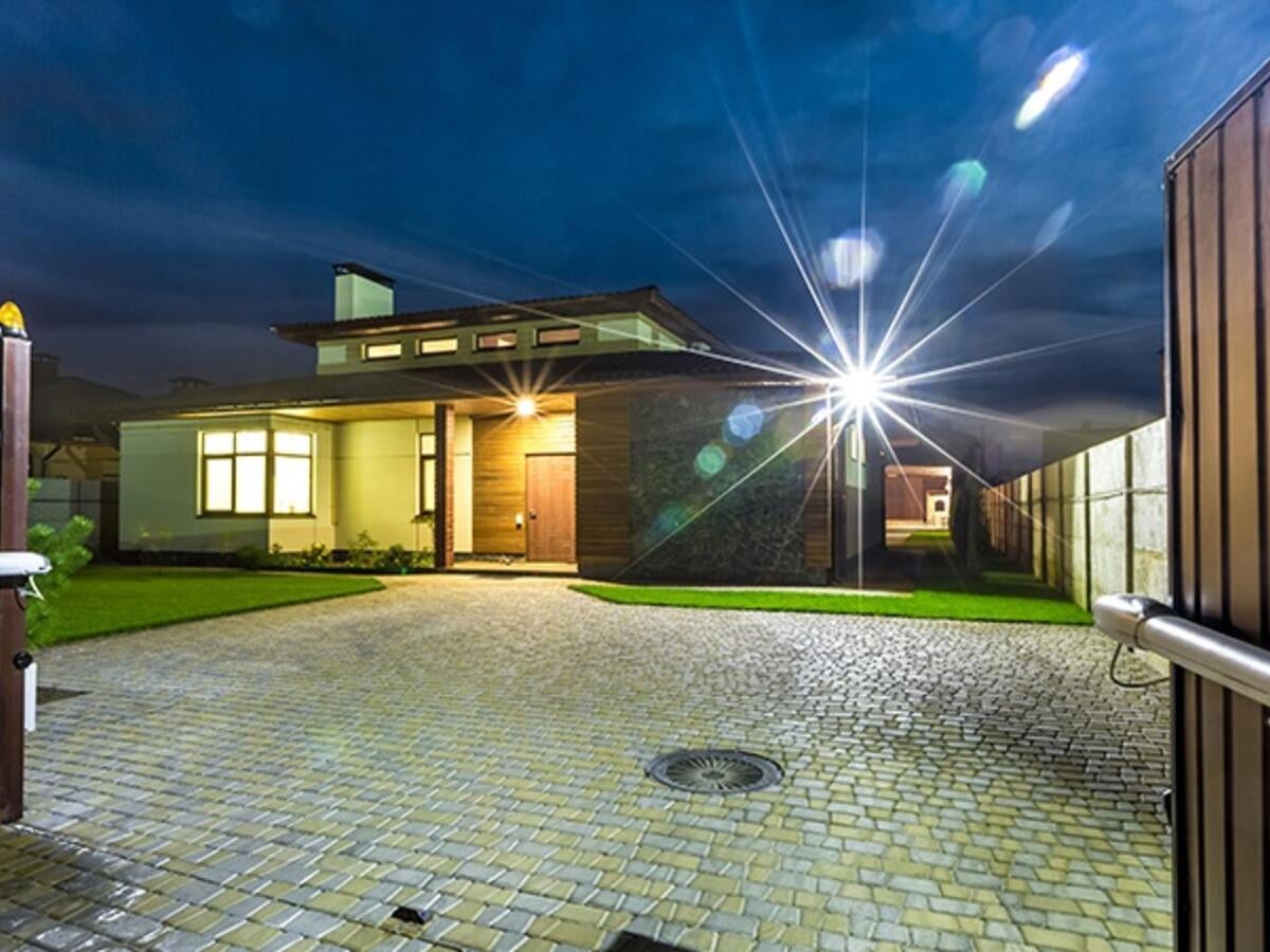 Luxury house with spotlight and electric gate security