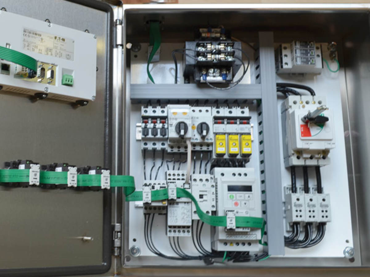 An opened industrial control panel showing components