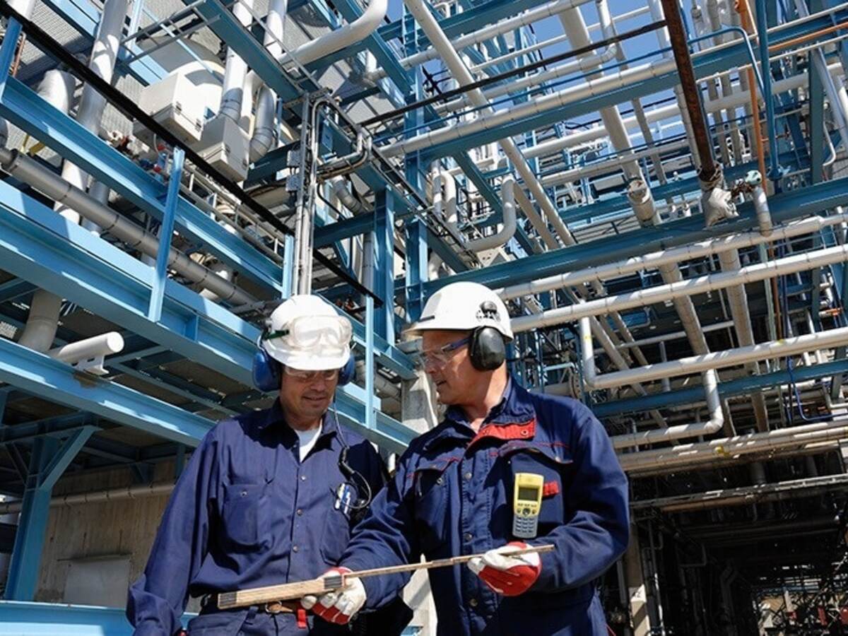 two workers at oil refinery