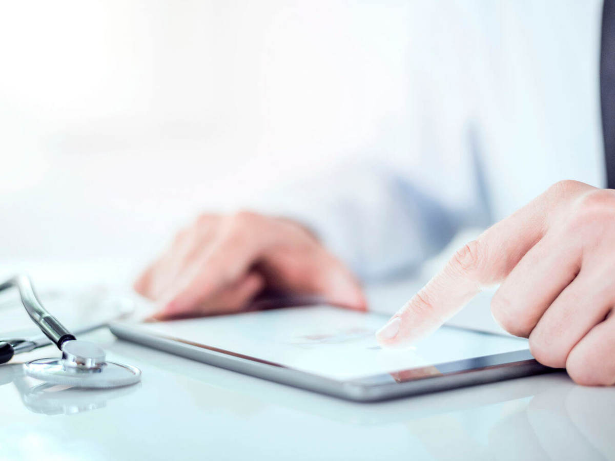 Cropped image of a doctor working on his digital tablet.He is showing digital tablet with blank screen