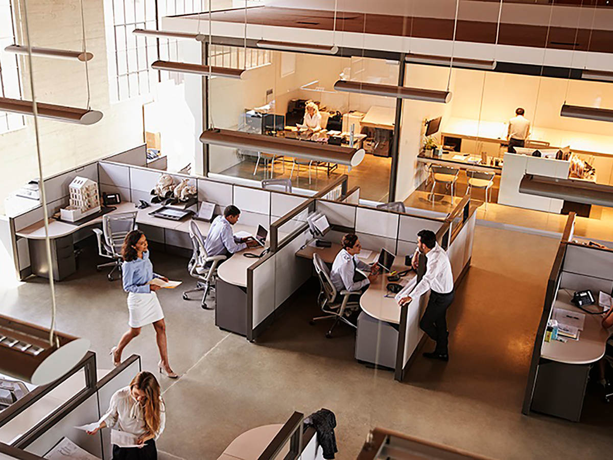 Photo of an office with cubicles and employees