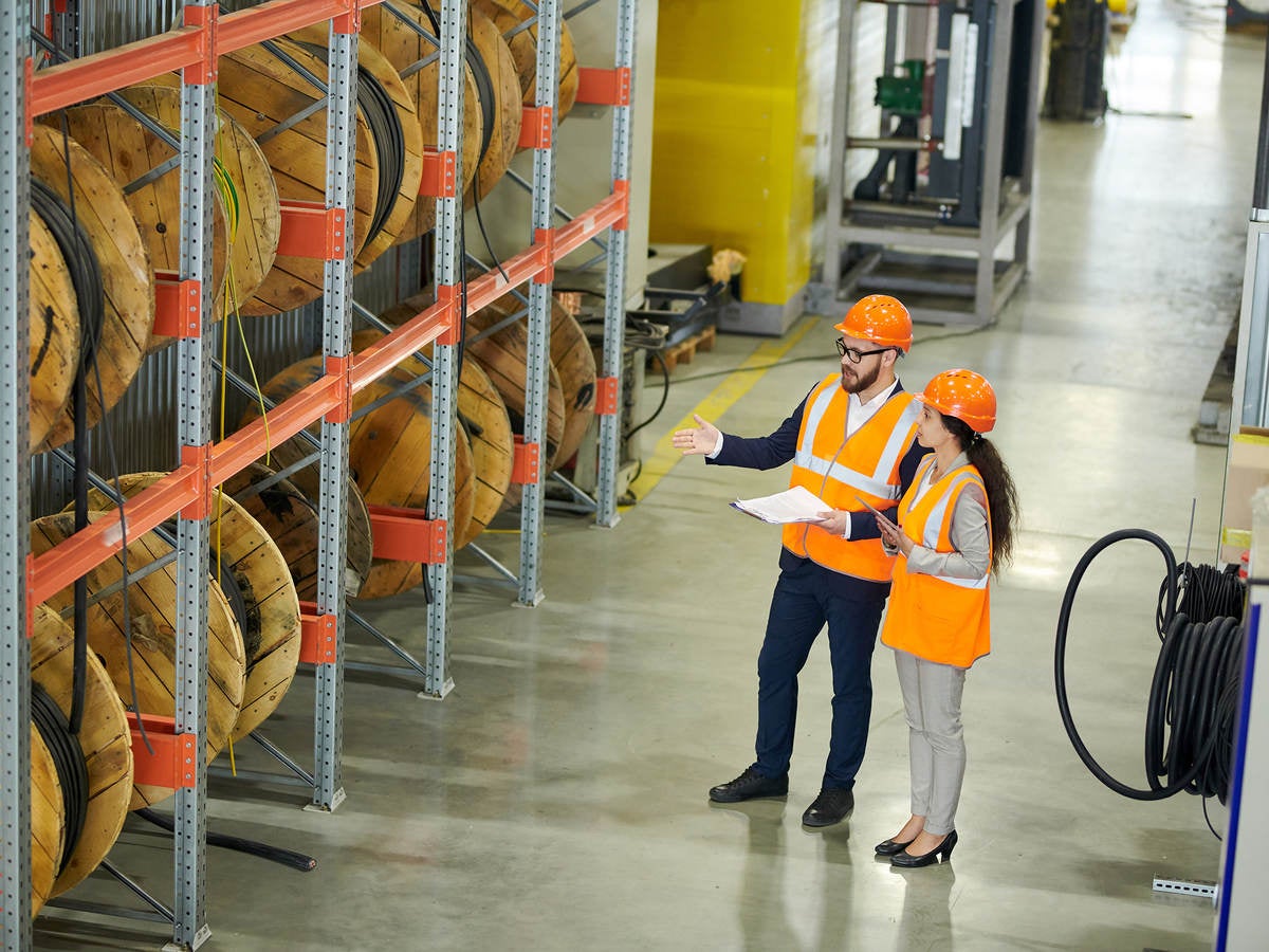 Workers auditing a warehouse