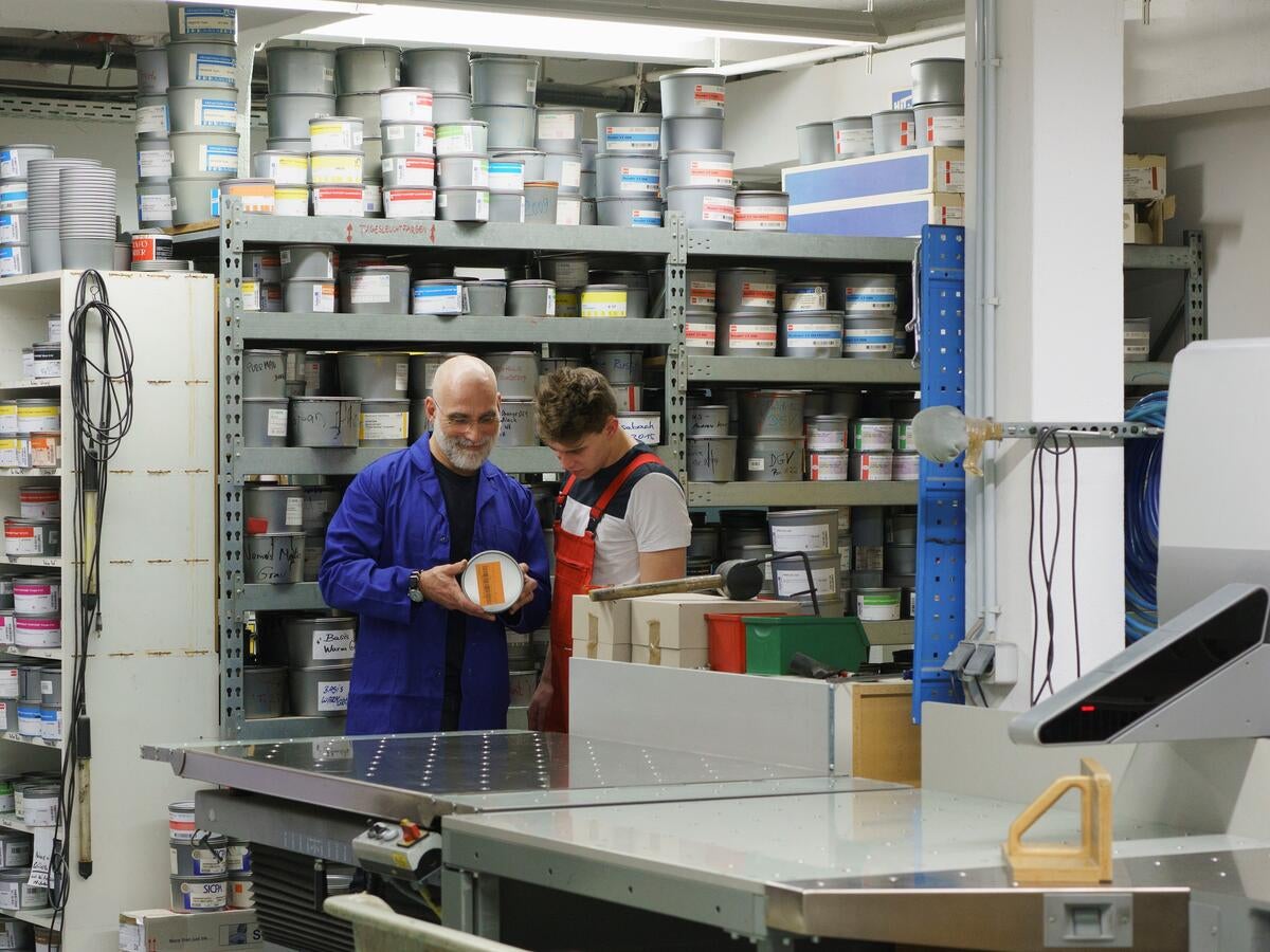 Workers looking at a paint can