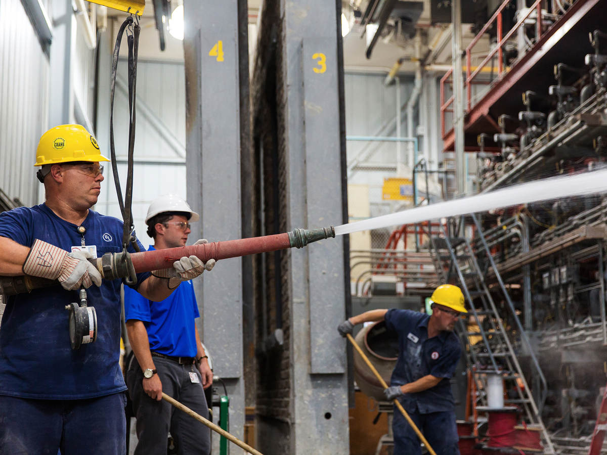 Photo of men in hardhats testing fire doors 