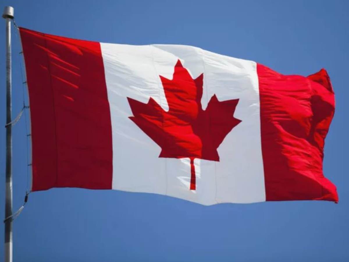 Canada flag against blue sky