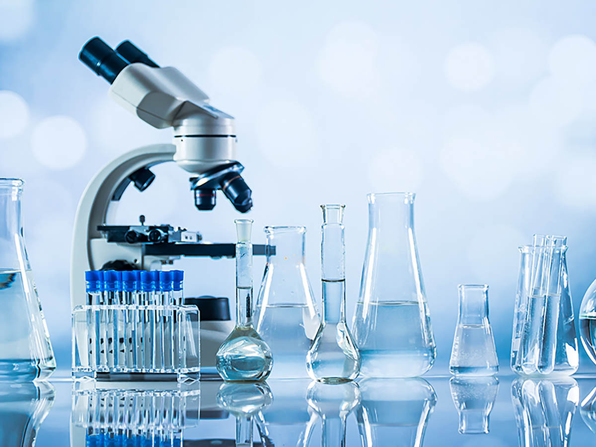 Microscope with glass laboratory equipment