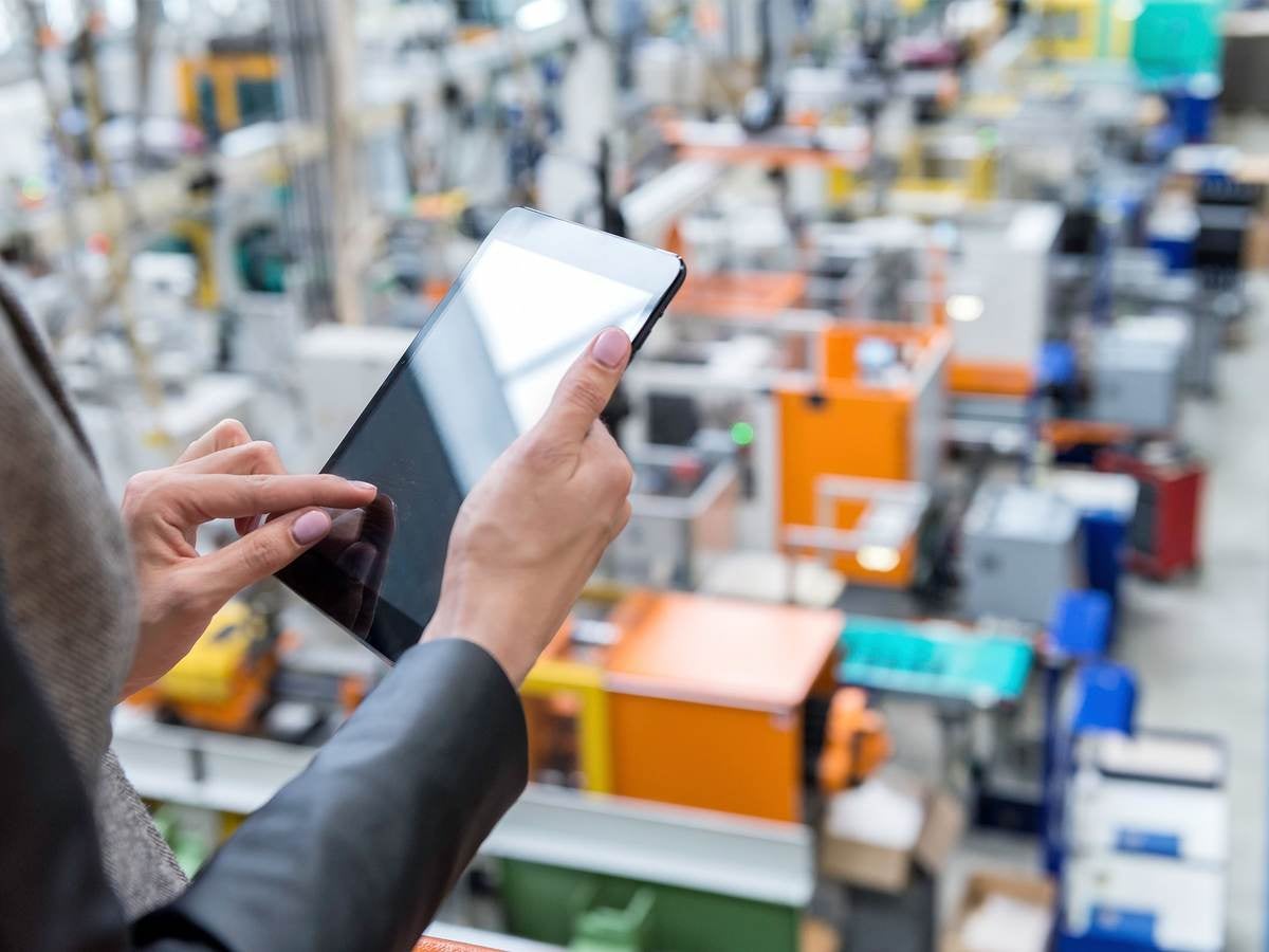 Manager working on tablet in factory