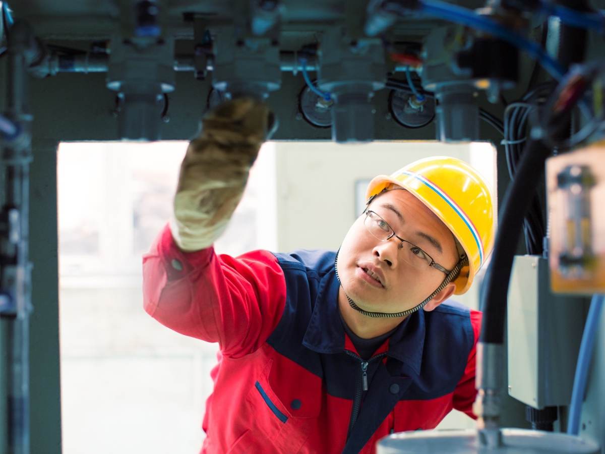 Person inspecting machinery